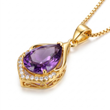 Elegant necklace with purple crystal — gold, close-up